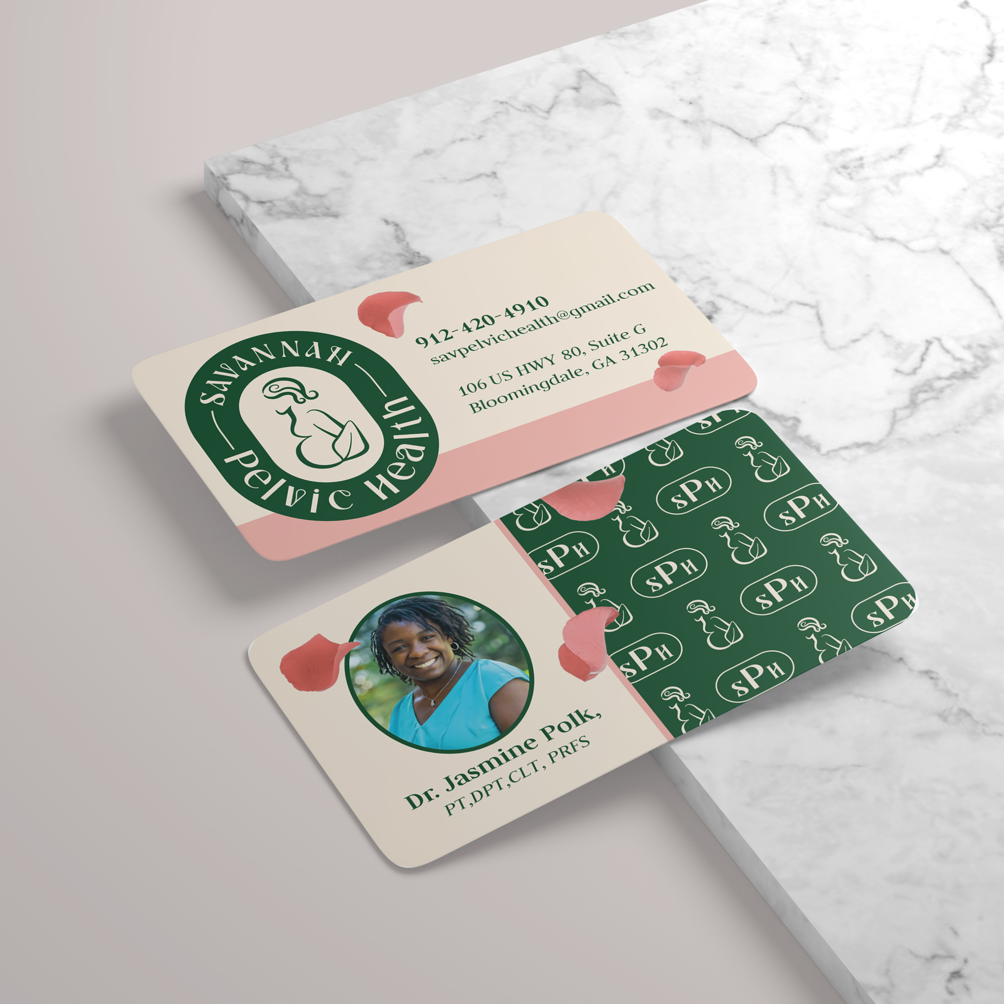 Business card with logo, contact info, and a photo of a woman, placed on a marble surface.